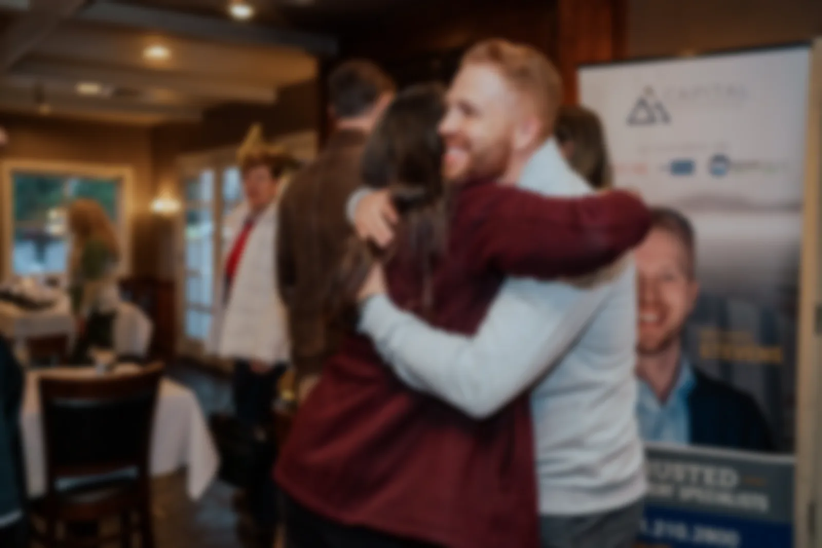 Mike Stevens embracing a client at a Capital Wealth event