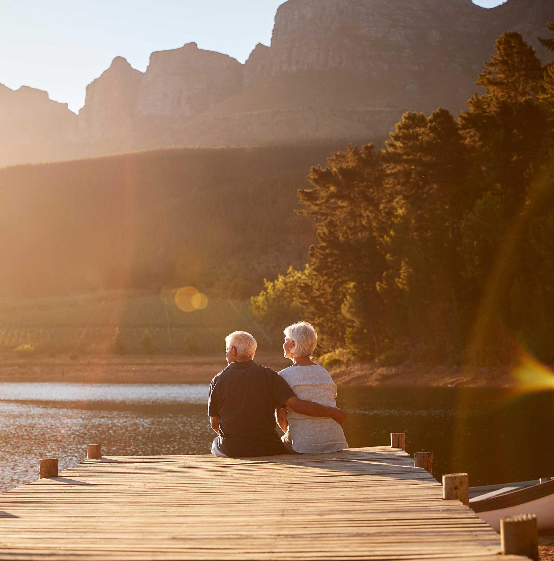 A retired couple at sunset on a lake dock